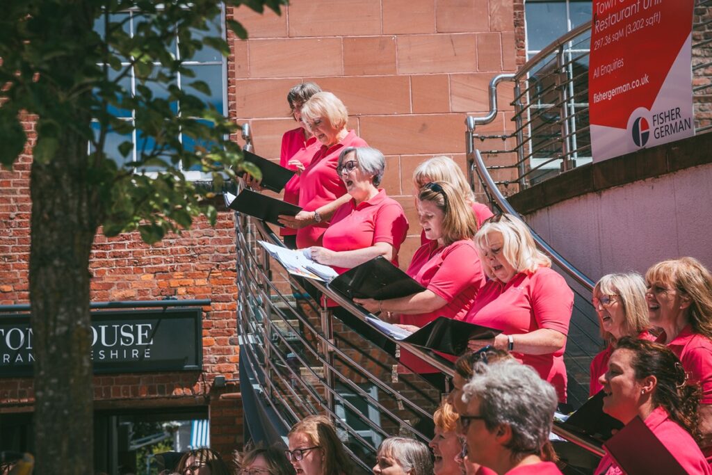 A choir on stairs outside