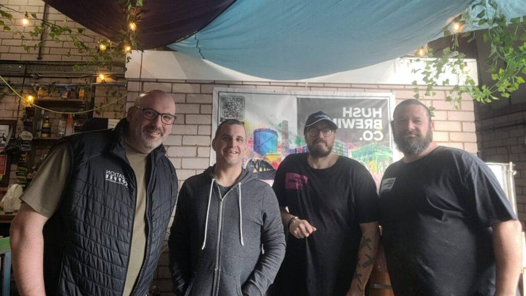 four gentlemen standing in line smiling