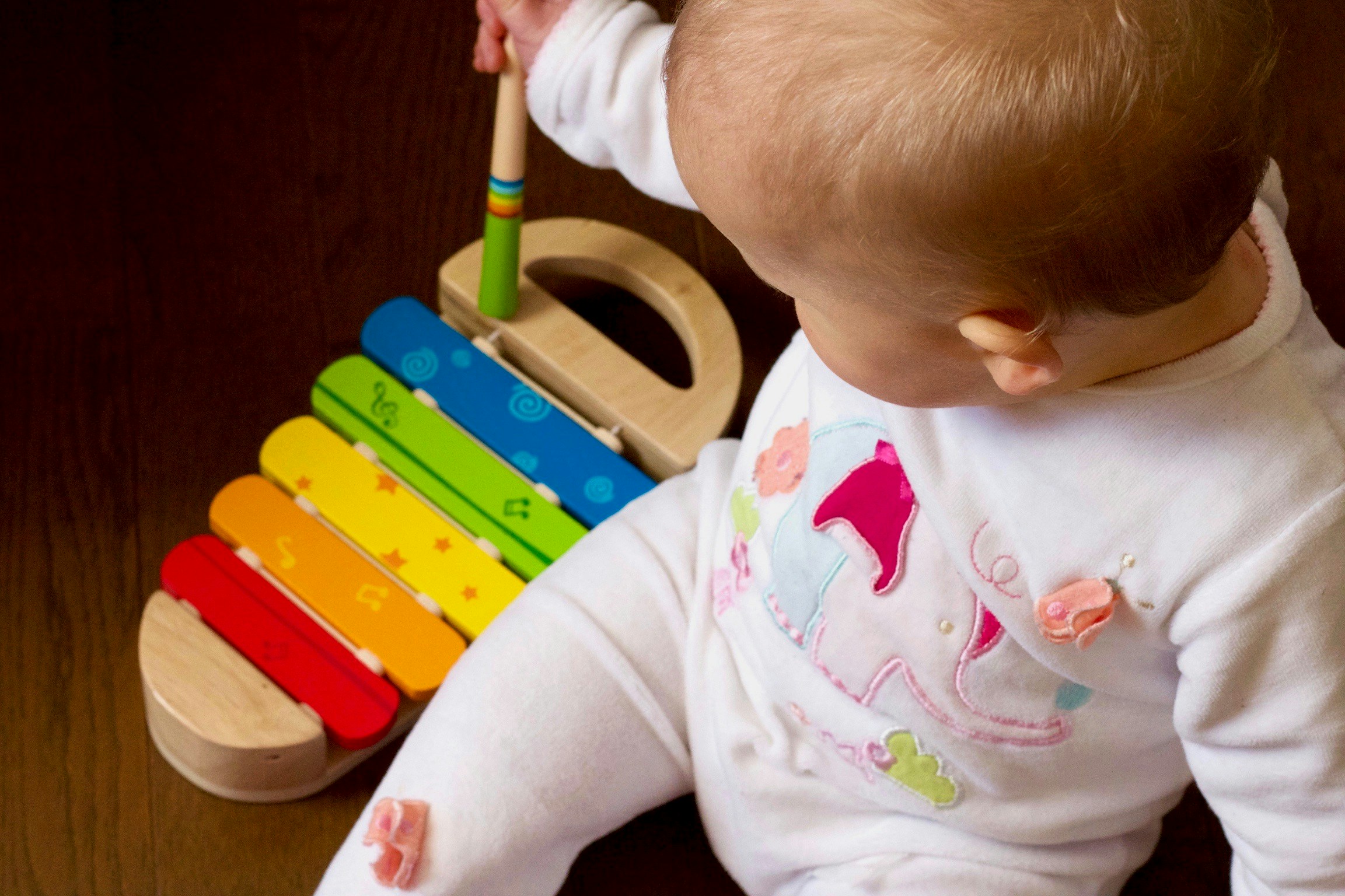 A baby playing a xylophone